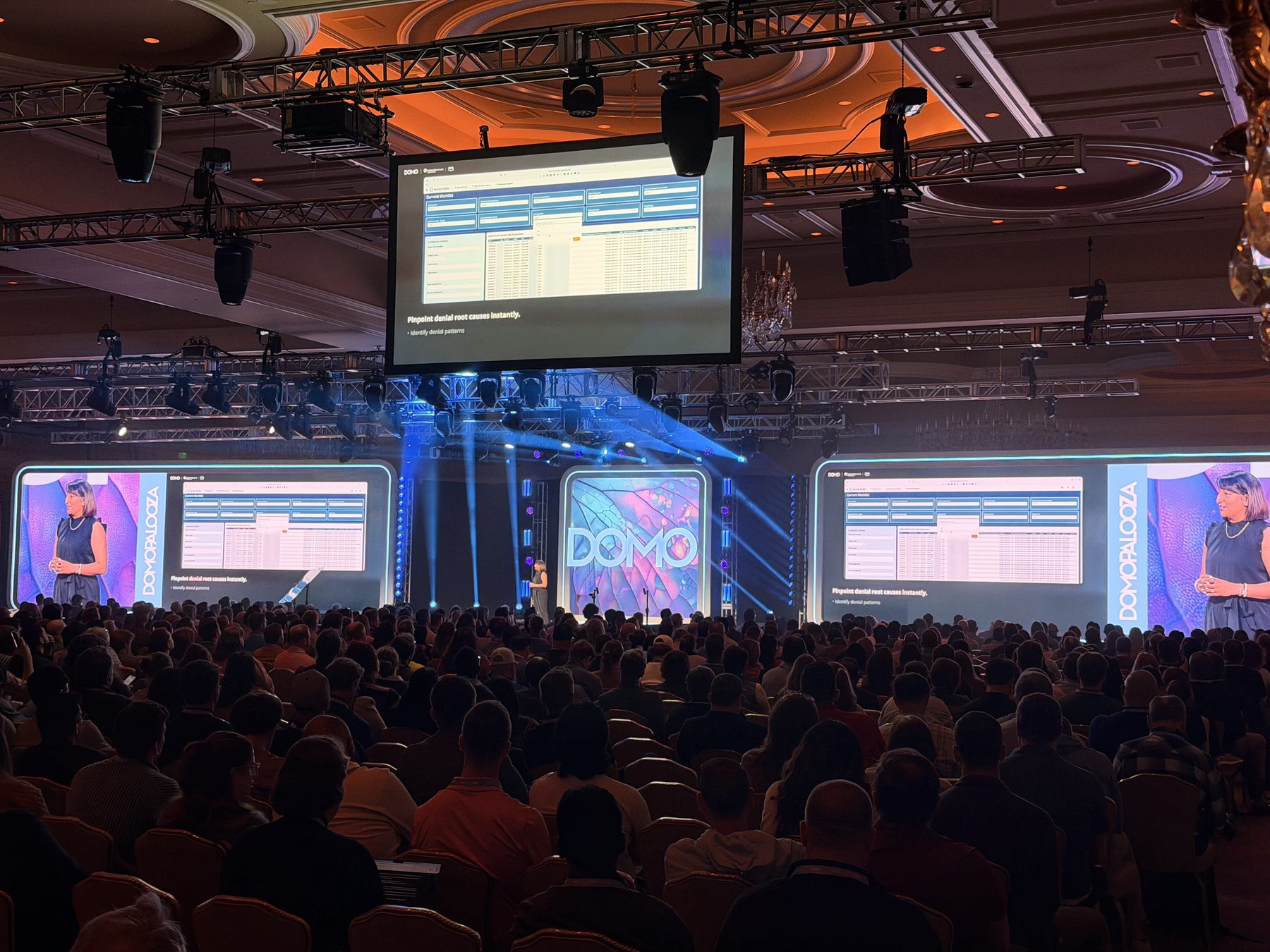 Jani presenting on stage to a packed ballroom at Domopalooza